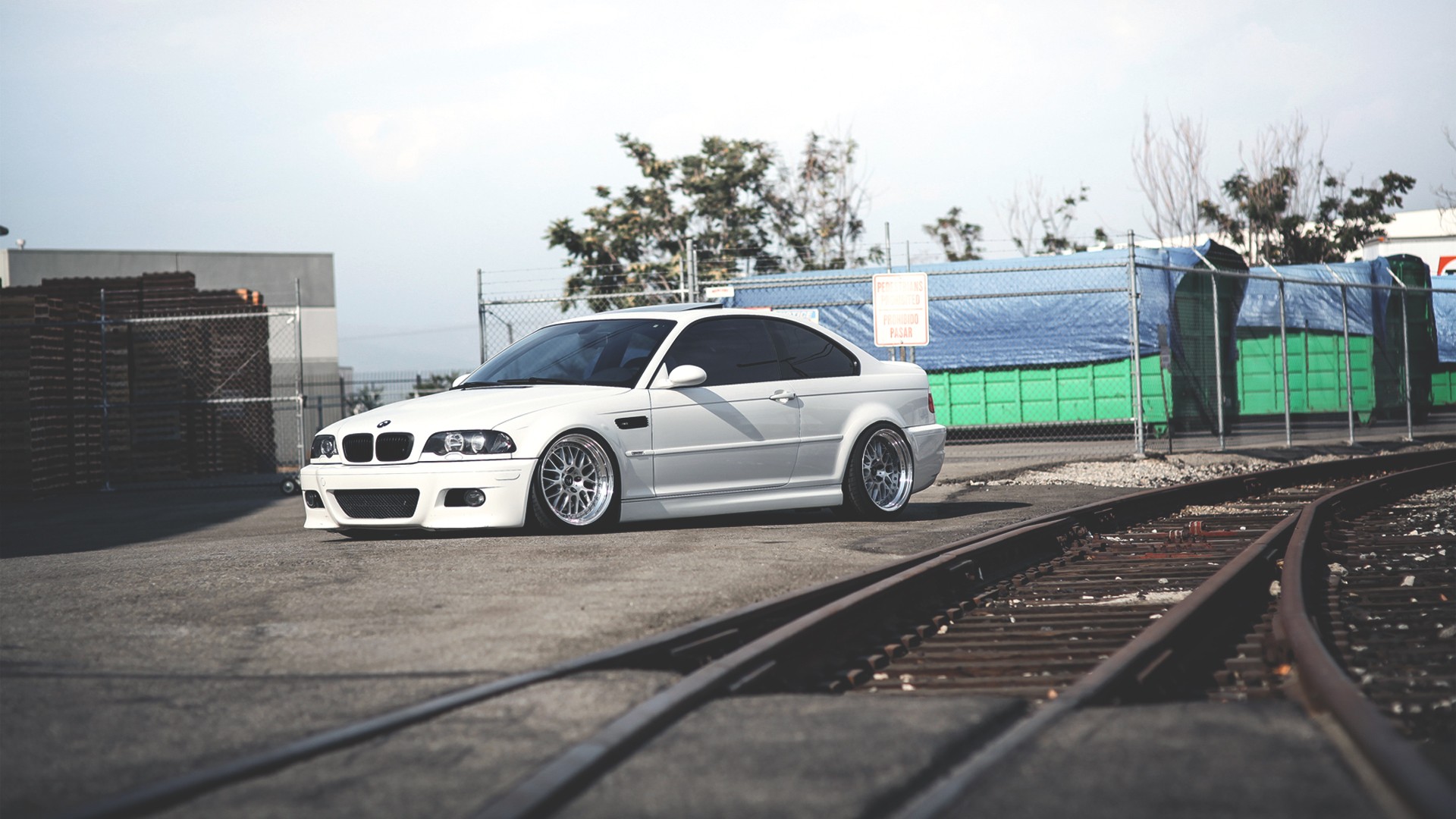 white bmw on train tracks