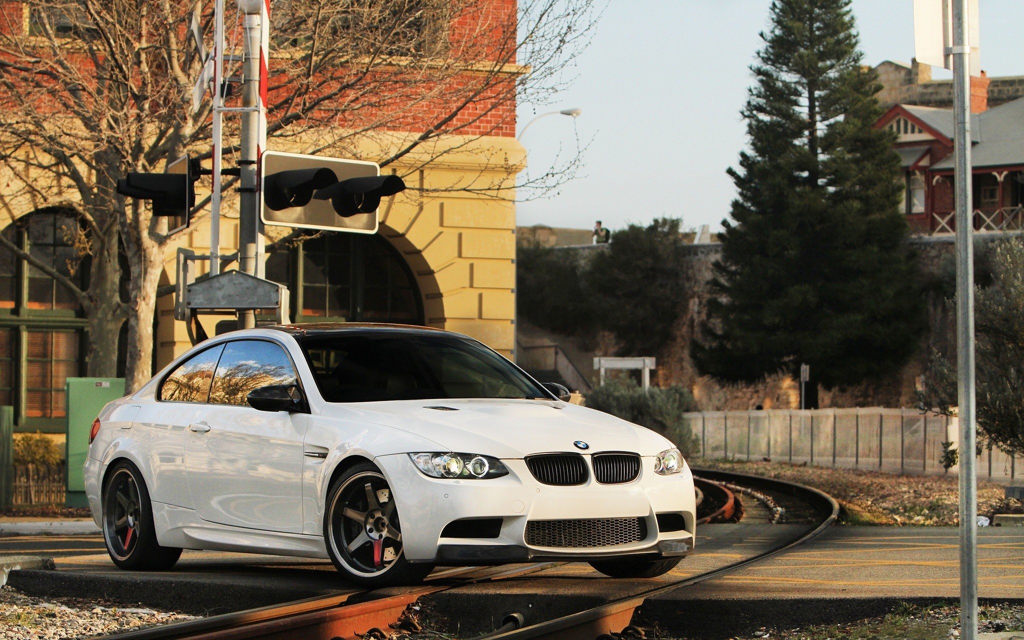 white bmw on train tracks