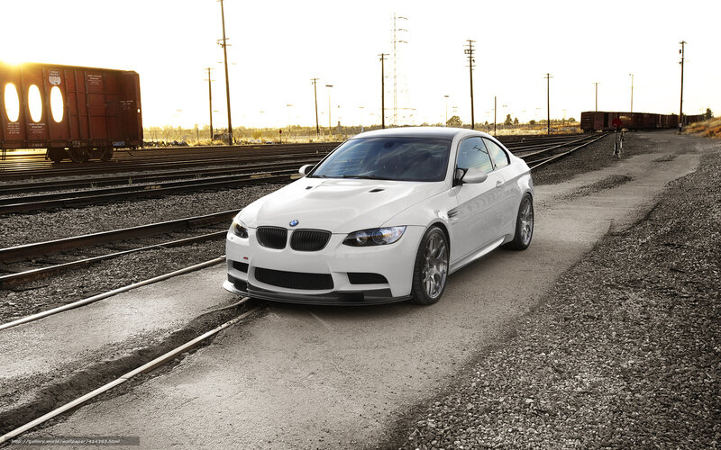 White BMW on train tracks