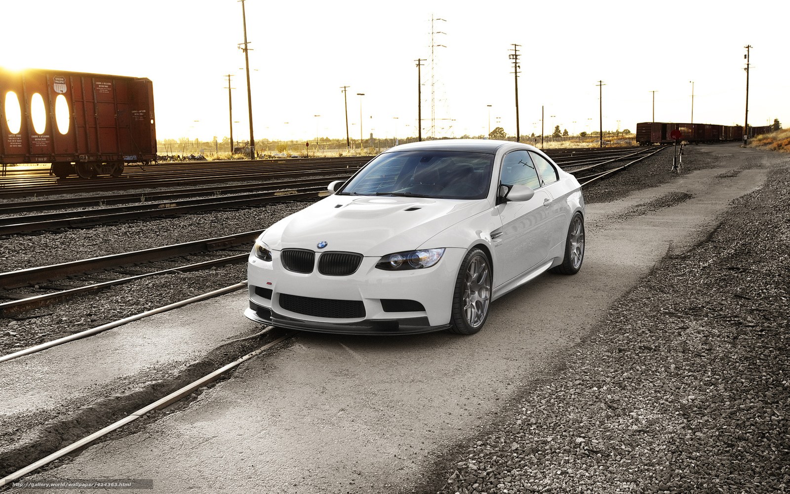 White BMW on train tracks