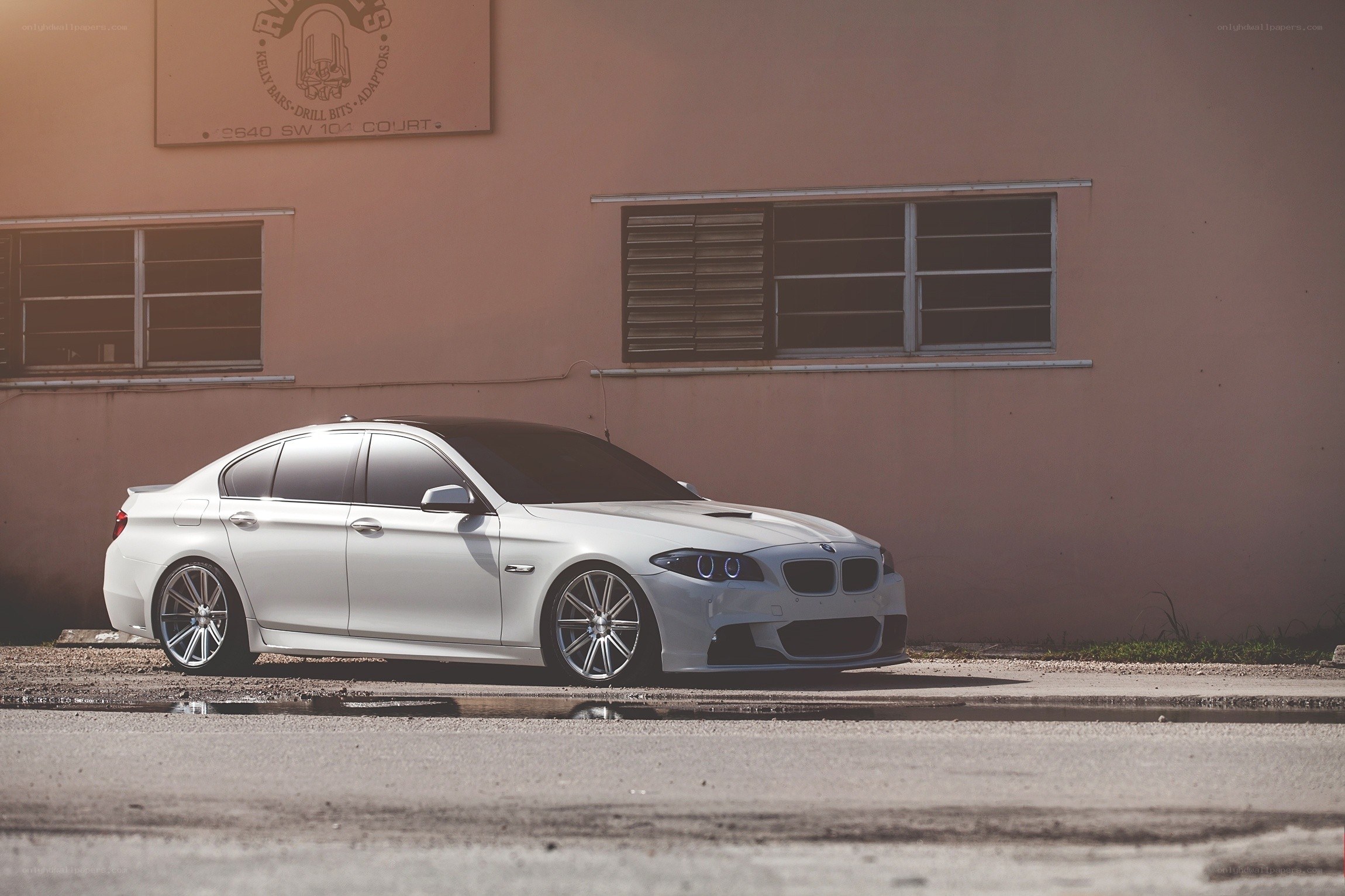 White BMW parked by building