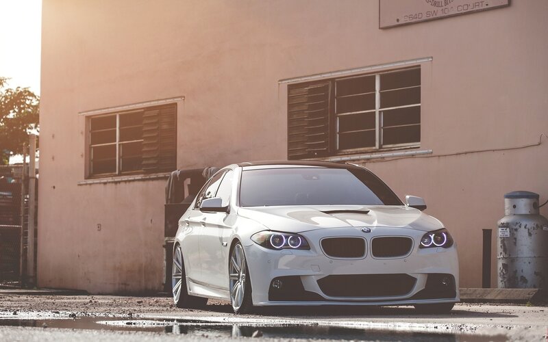white bmw parked in alley
