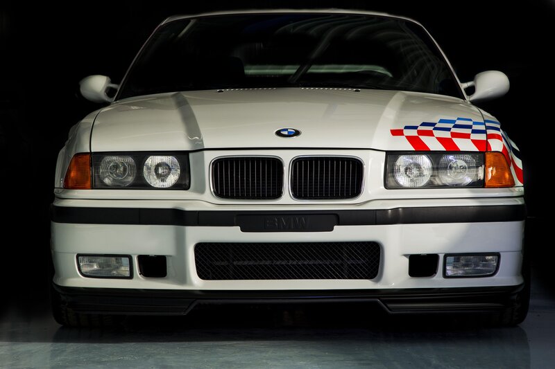 White BMW Race Car — Dramatic, Photograph, Checkered Flag