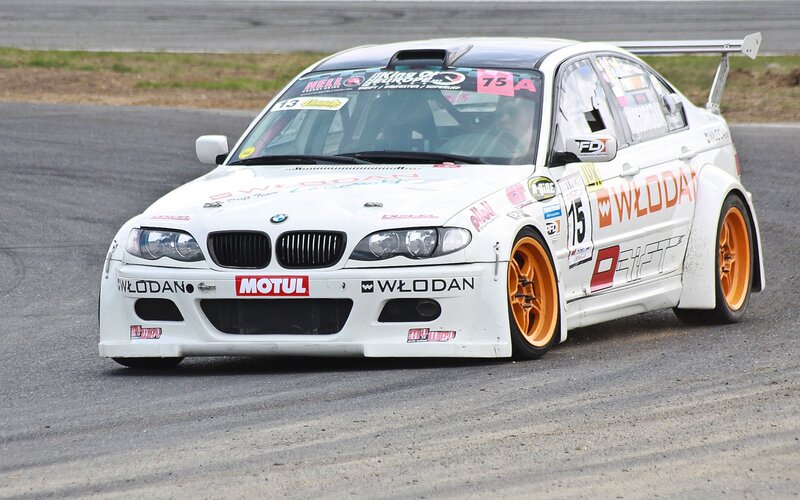 white BMW race car on track