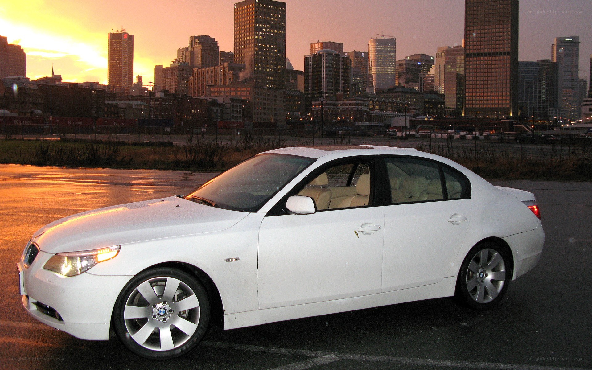 White BMW sedan at sunset