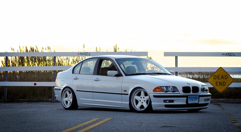 white bmw sedan at sunset