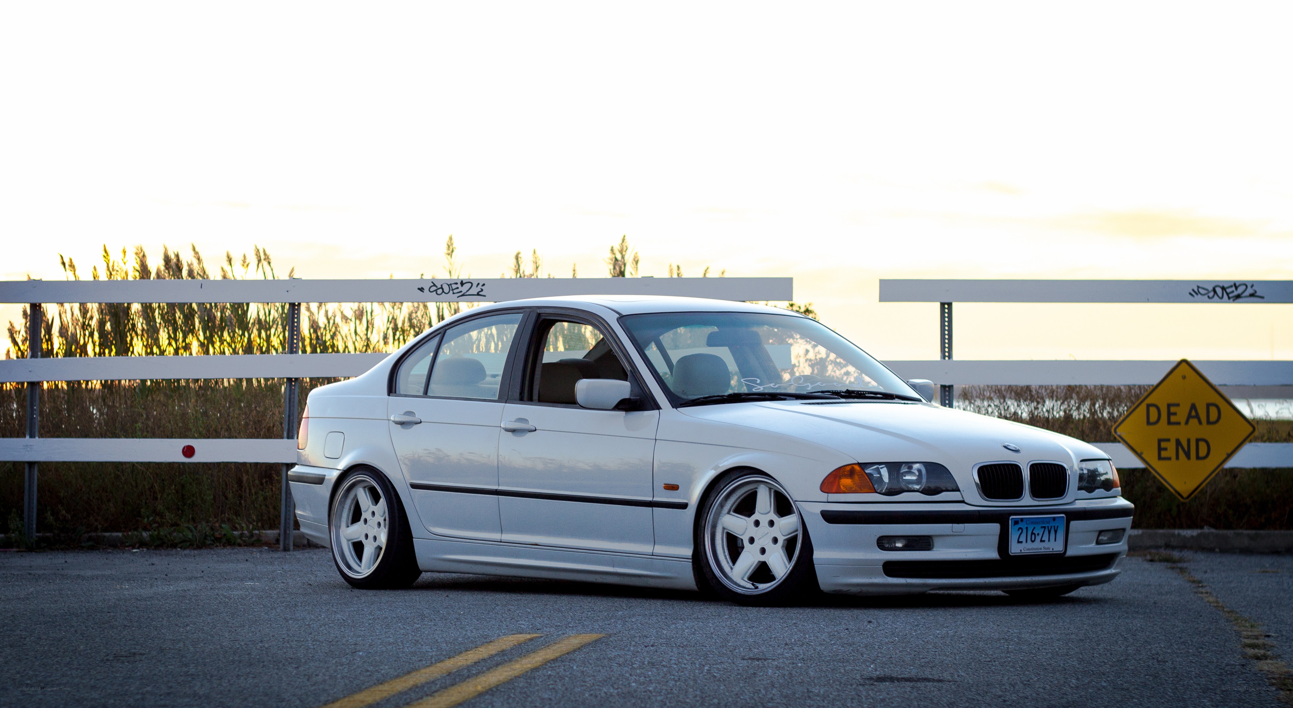 white bmw sedan at sunset
