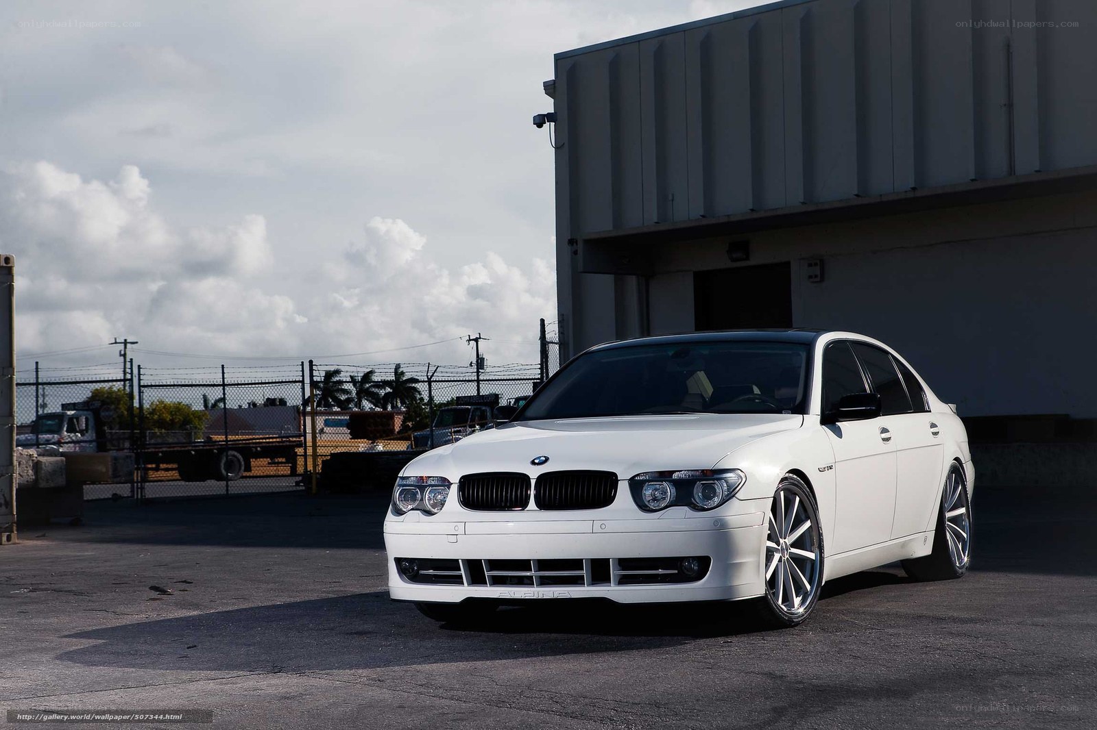 White BMW sedan in industrial lot