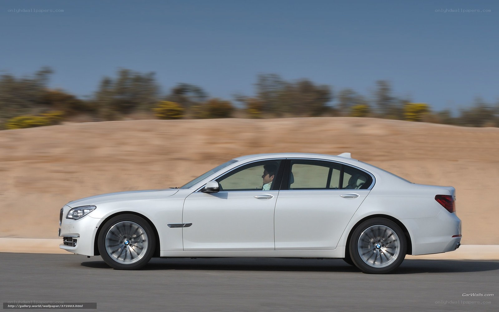 white bmw sedan in motion