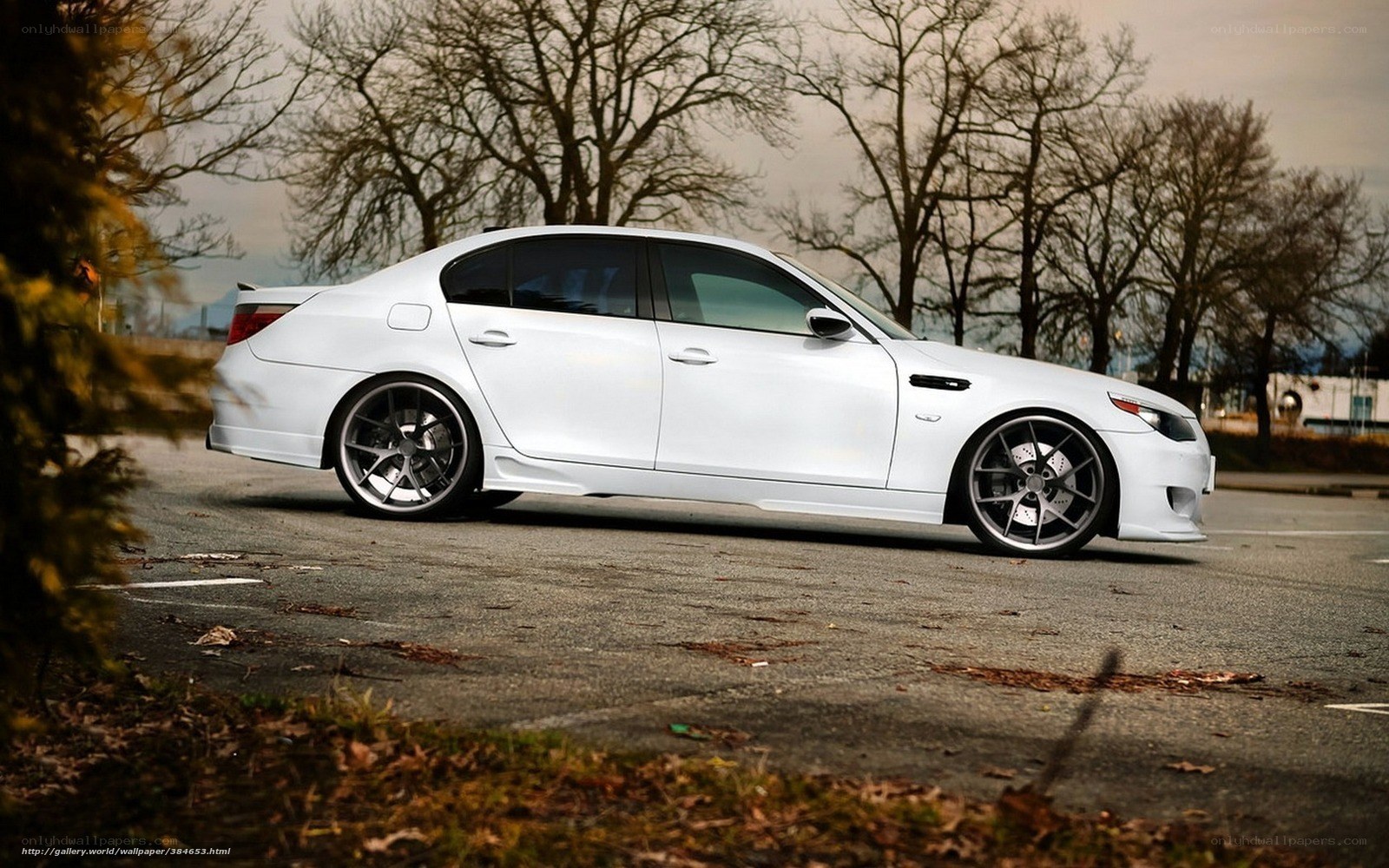 white bmw sedan on asphalt