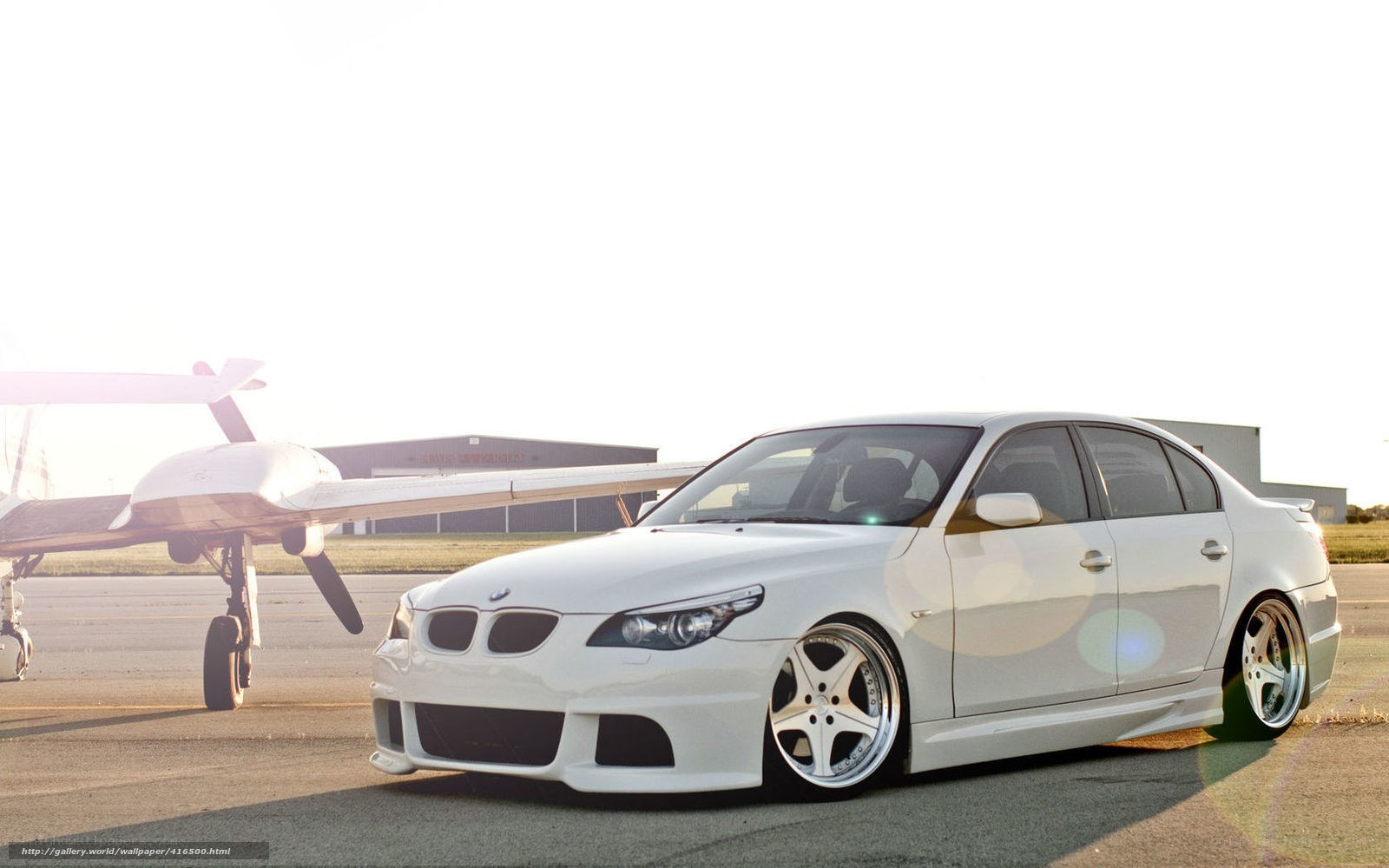 white bmw sedan on tarmac