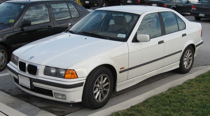 white bmw sedan parked