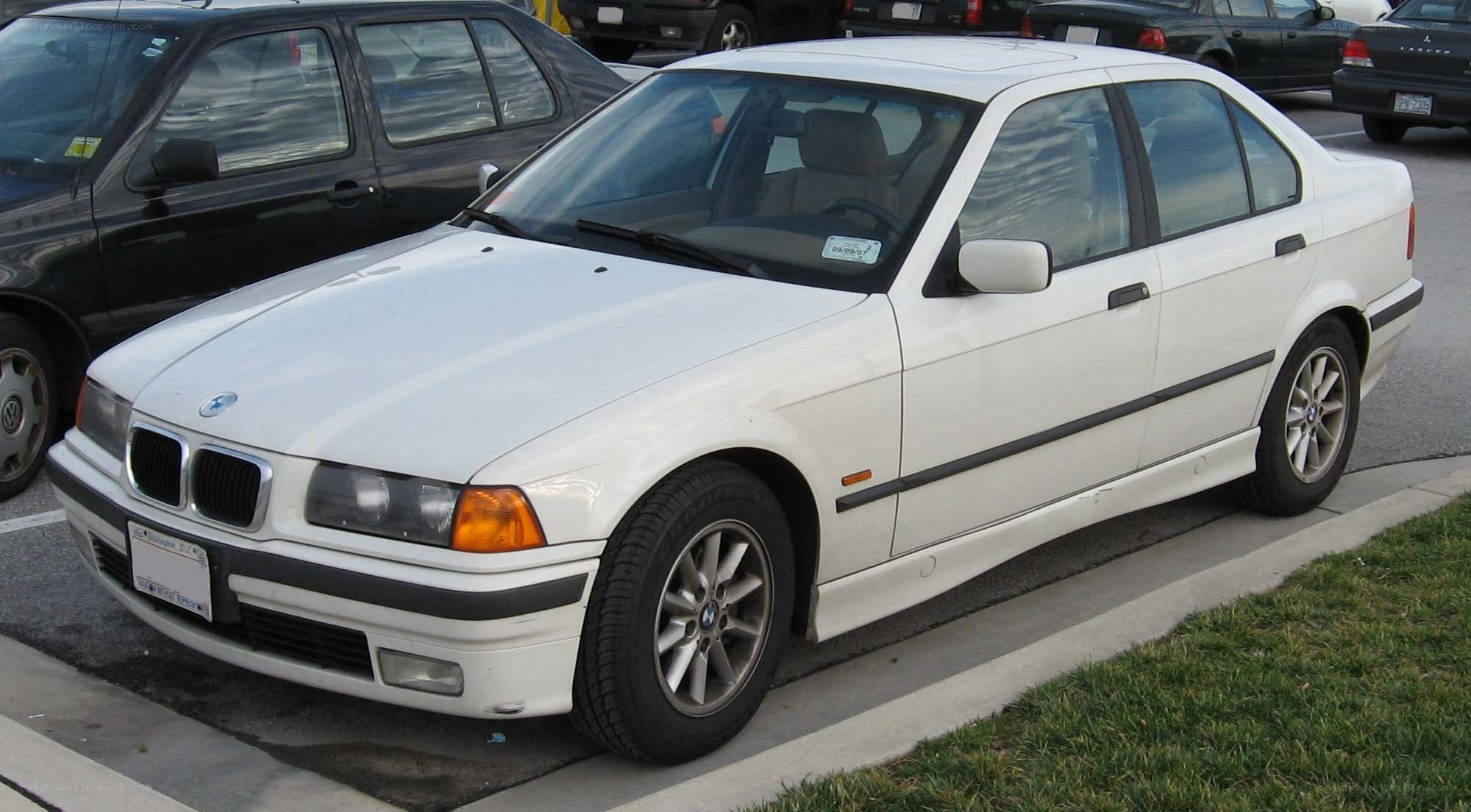 white bmw sedan parked