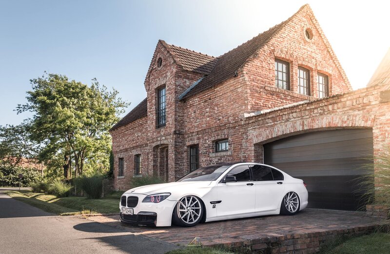 White BMW Sedan — Serene, Afternoon, Photograph, Brick House