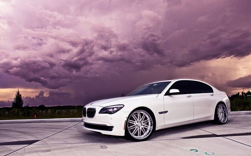 White BMW sedan under stormy sky