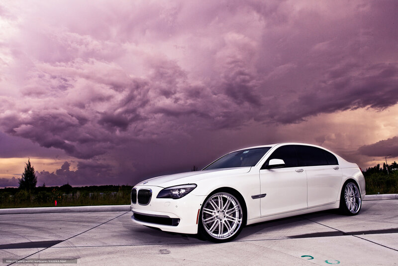 White BMW sedan under stormy sky