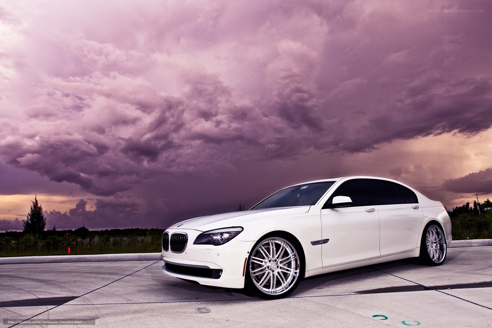 White BMW sedan under stormy sky