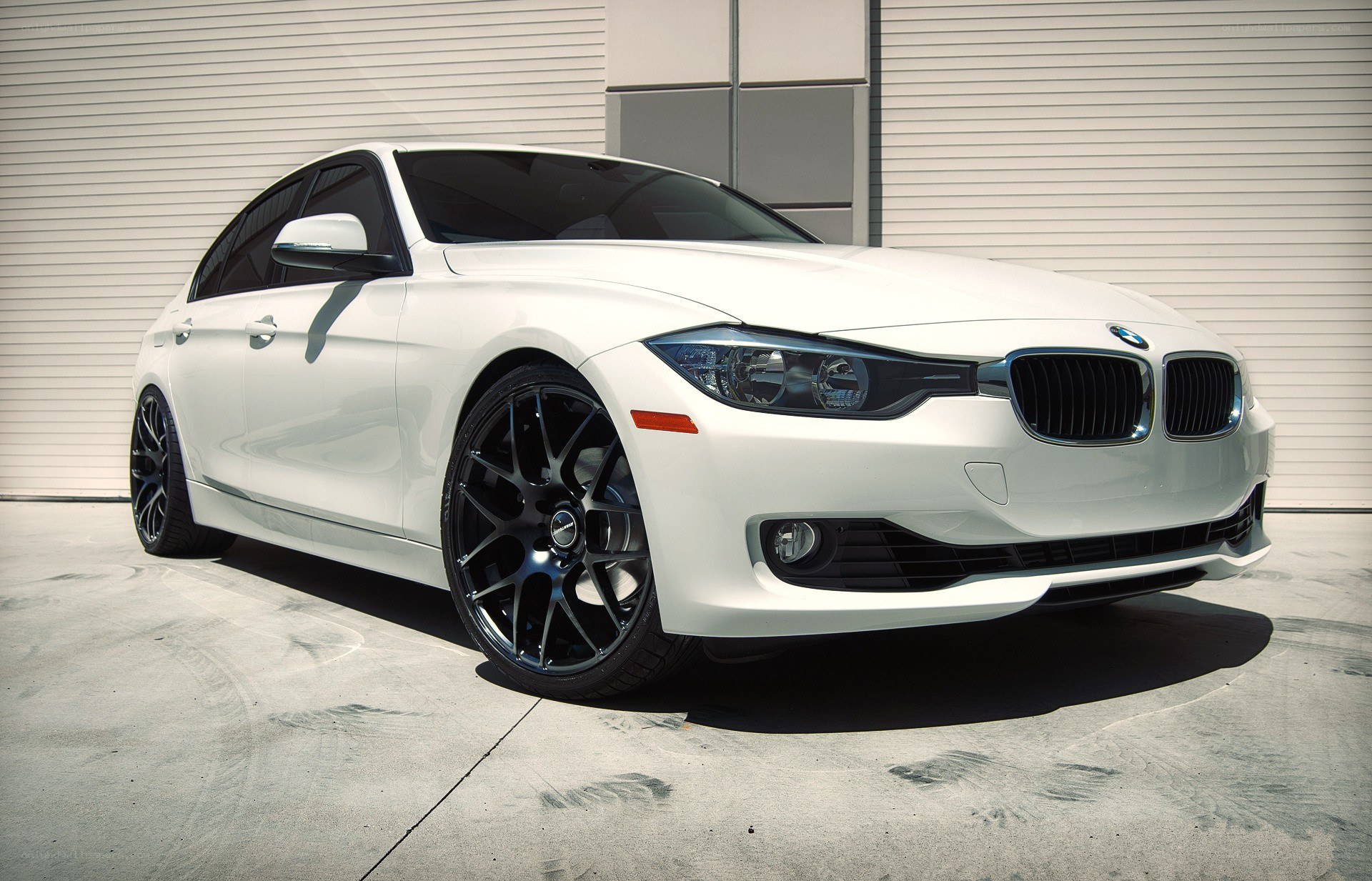 white bmw sedan with black wheels