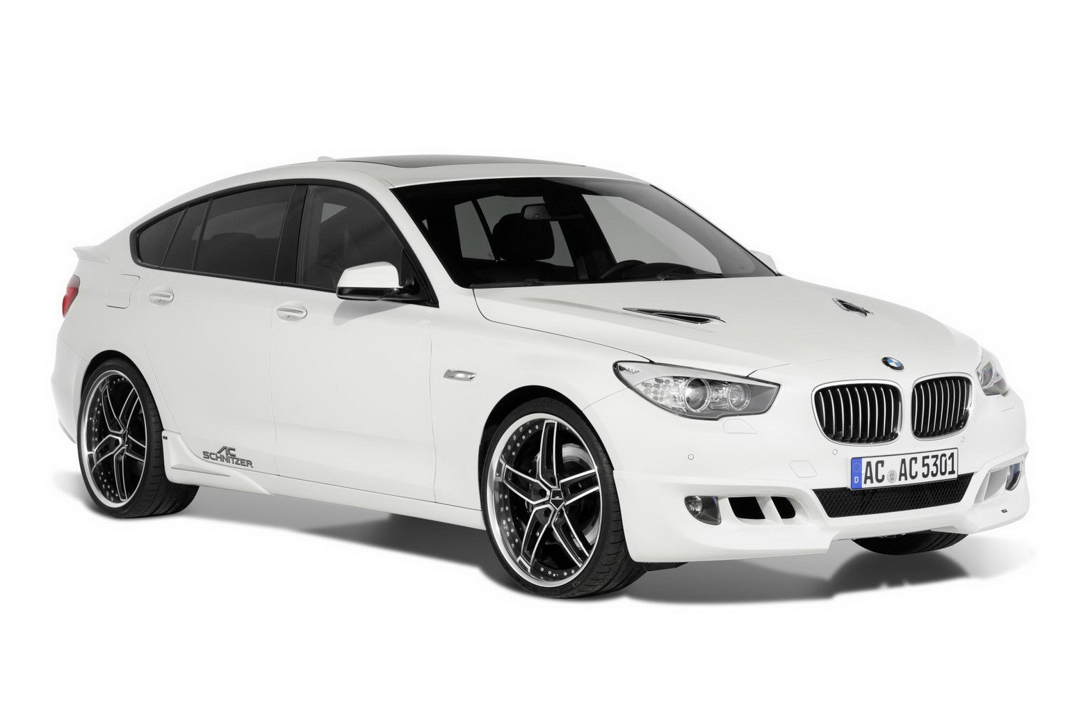 white bmw sedan with custom wheels