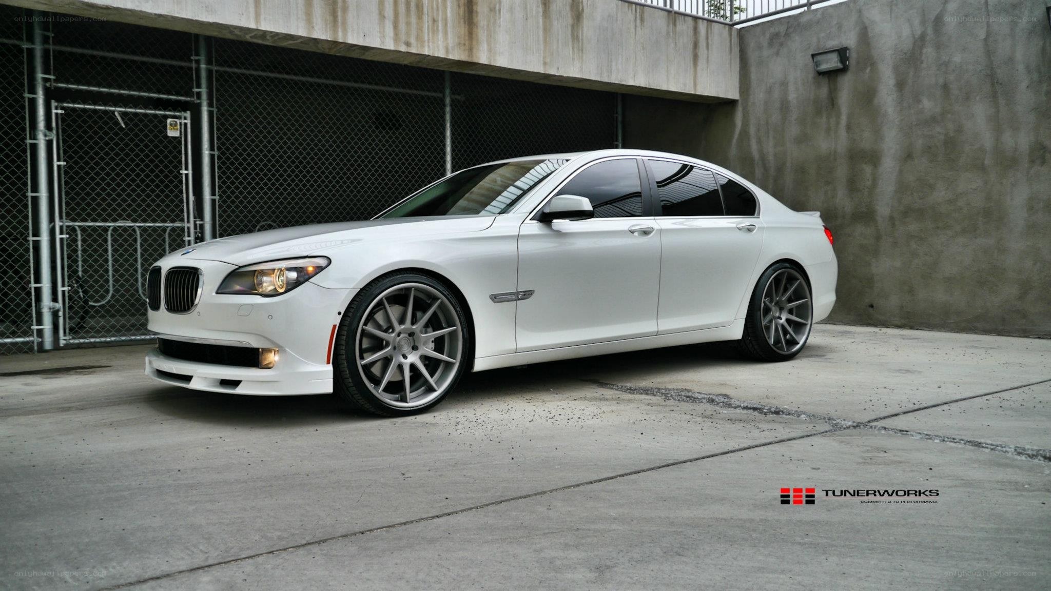 white bmw sedan with custom wheels