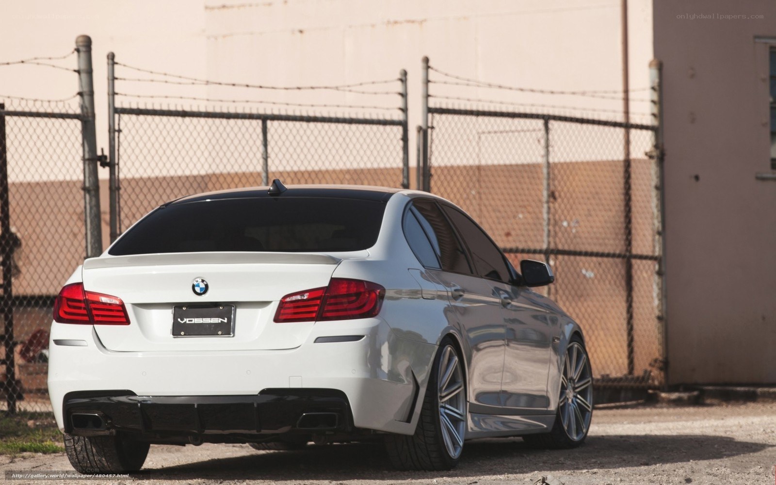 white bmw sedan with vossen wheels
