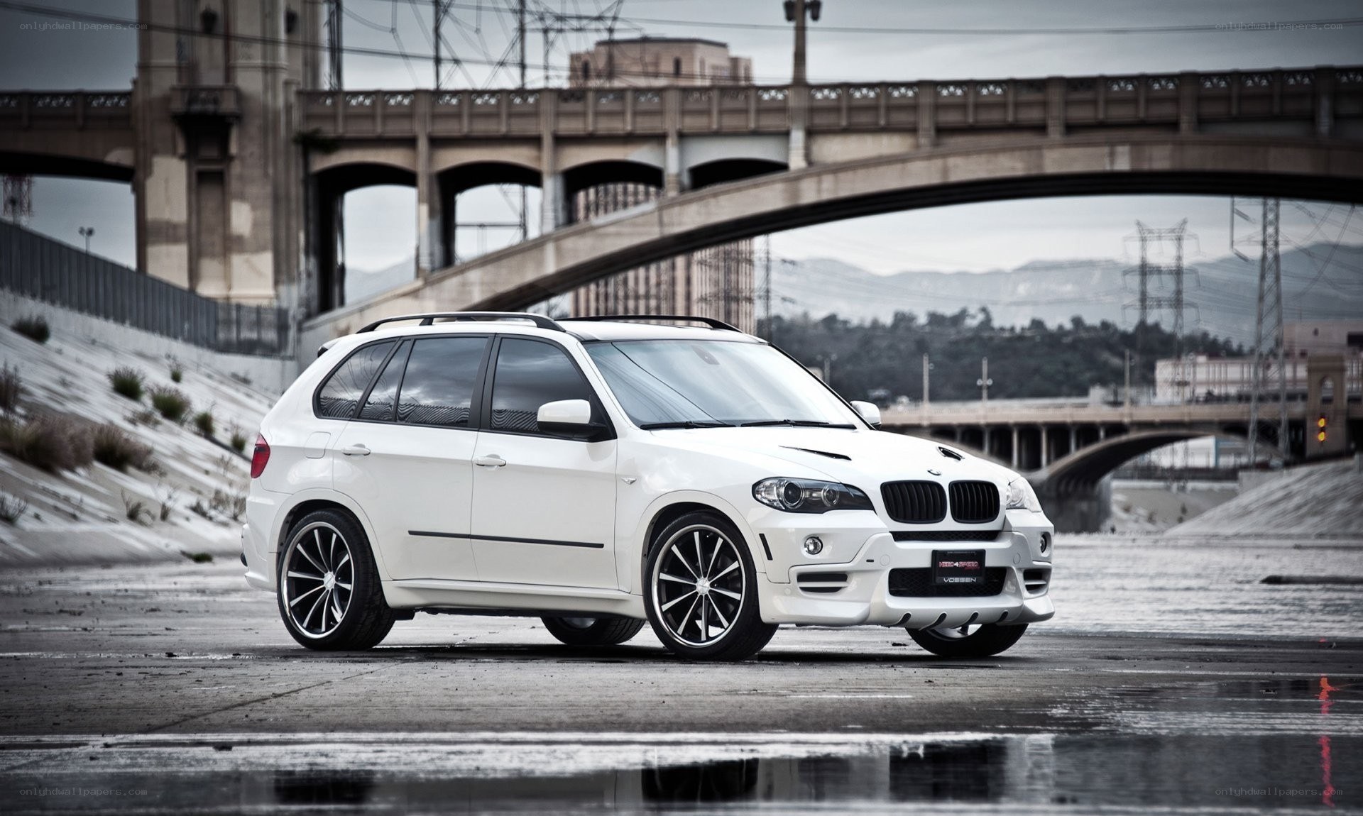 white bmw suv on wet pavement