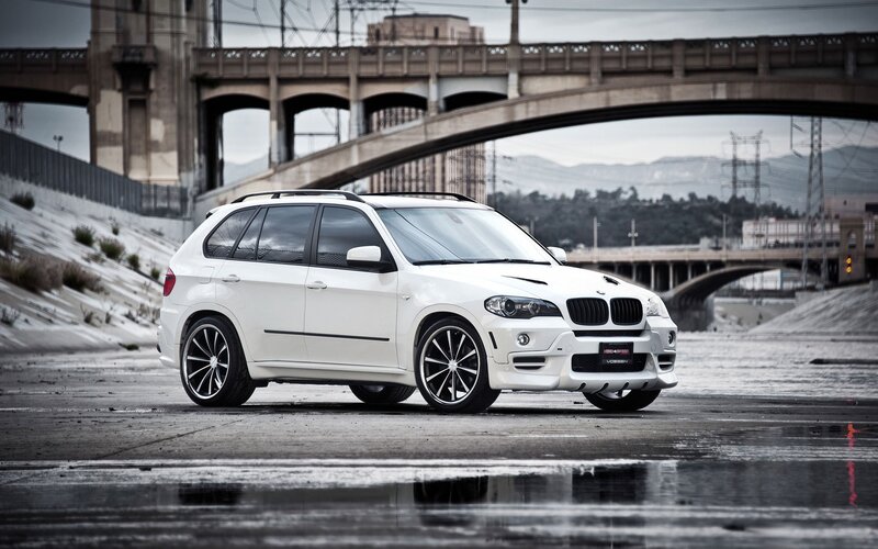 White BMW SUV on wet pavement