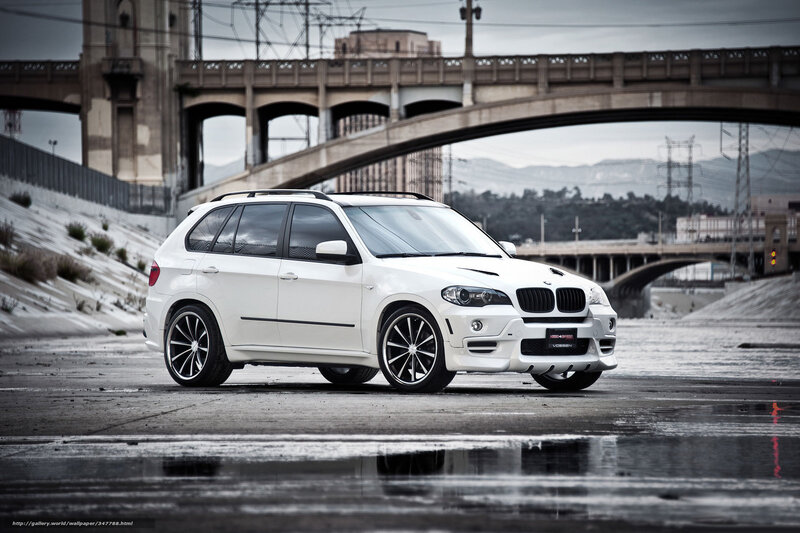 White BMW SUV on wet pavement