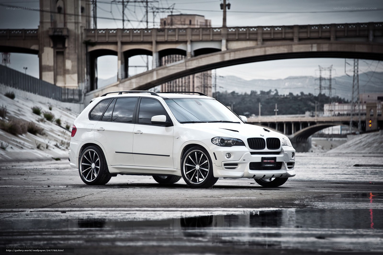 White BMW SUV on wet pavement