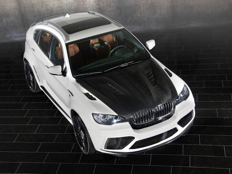 white bmw suv with carbon fiber