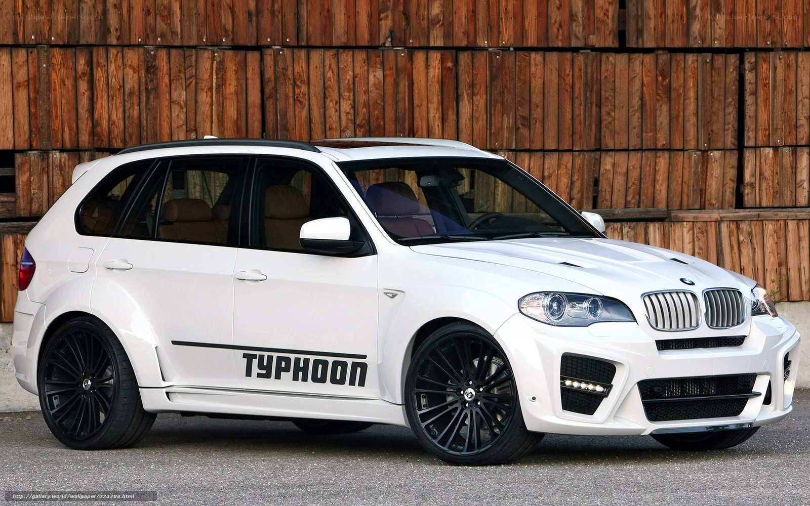 white bmw suv with typhoon branding