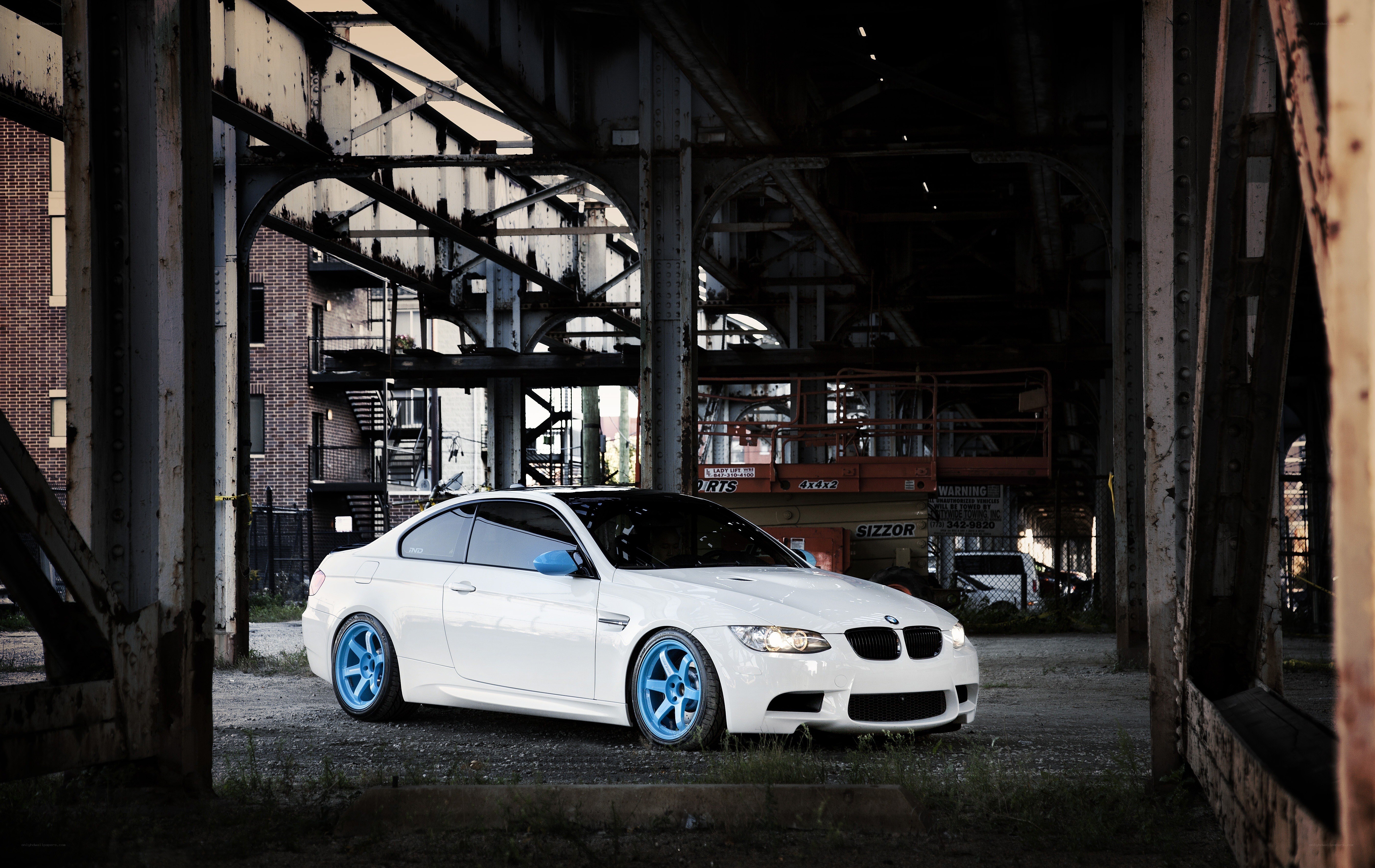 White BMW under a bridge