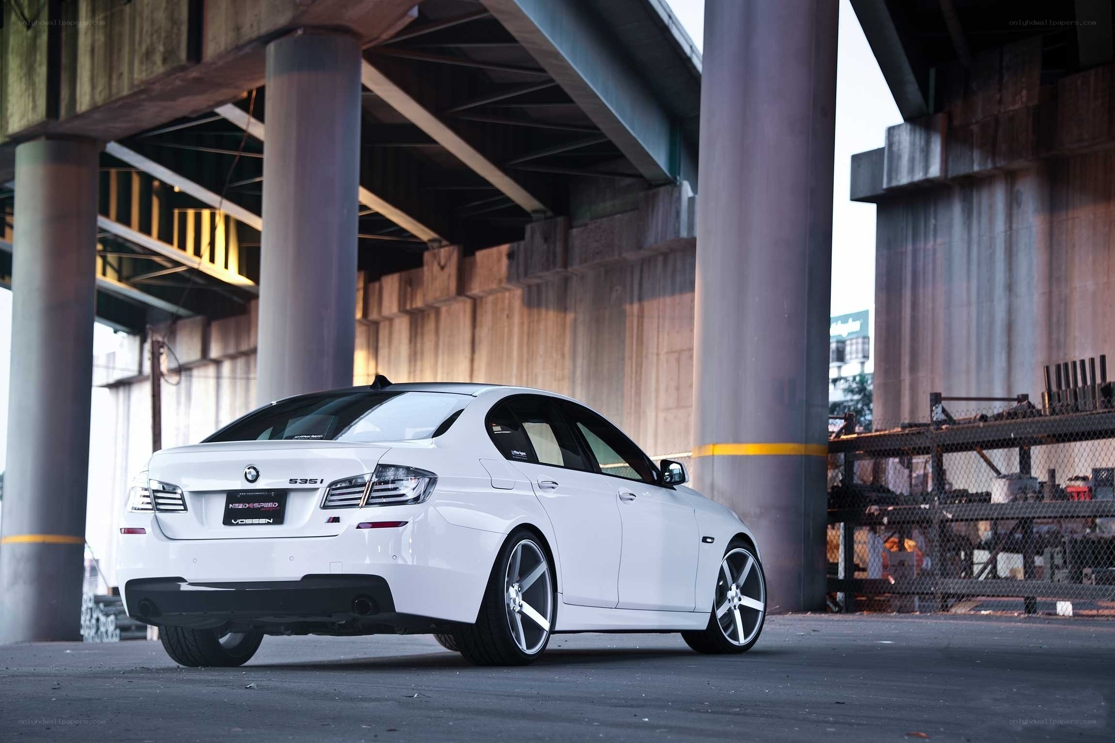 White BMW under a bridge