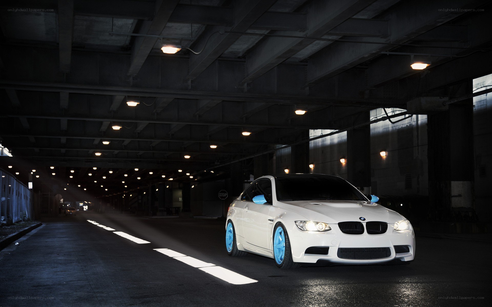 White BMW under a bridge