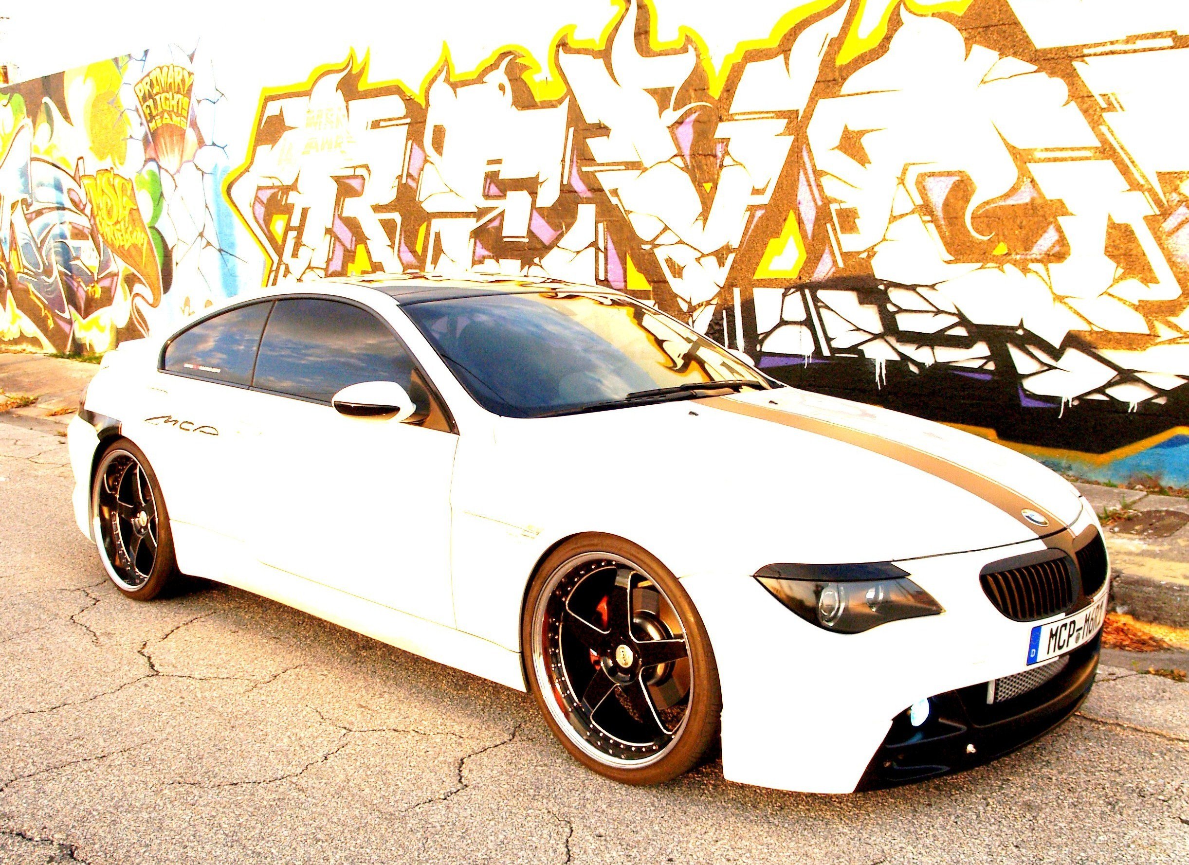 White BMW with graffiti background