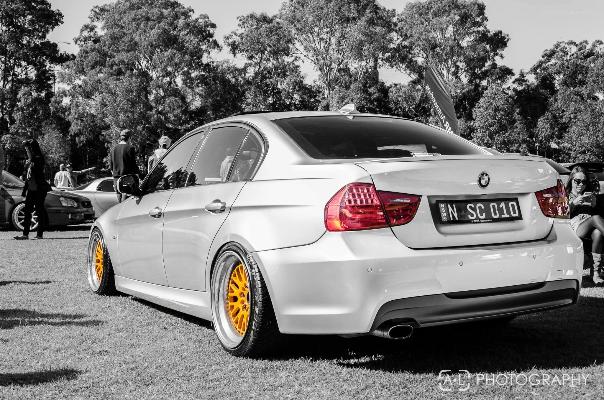 White BMW with yellow wheels