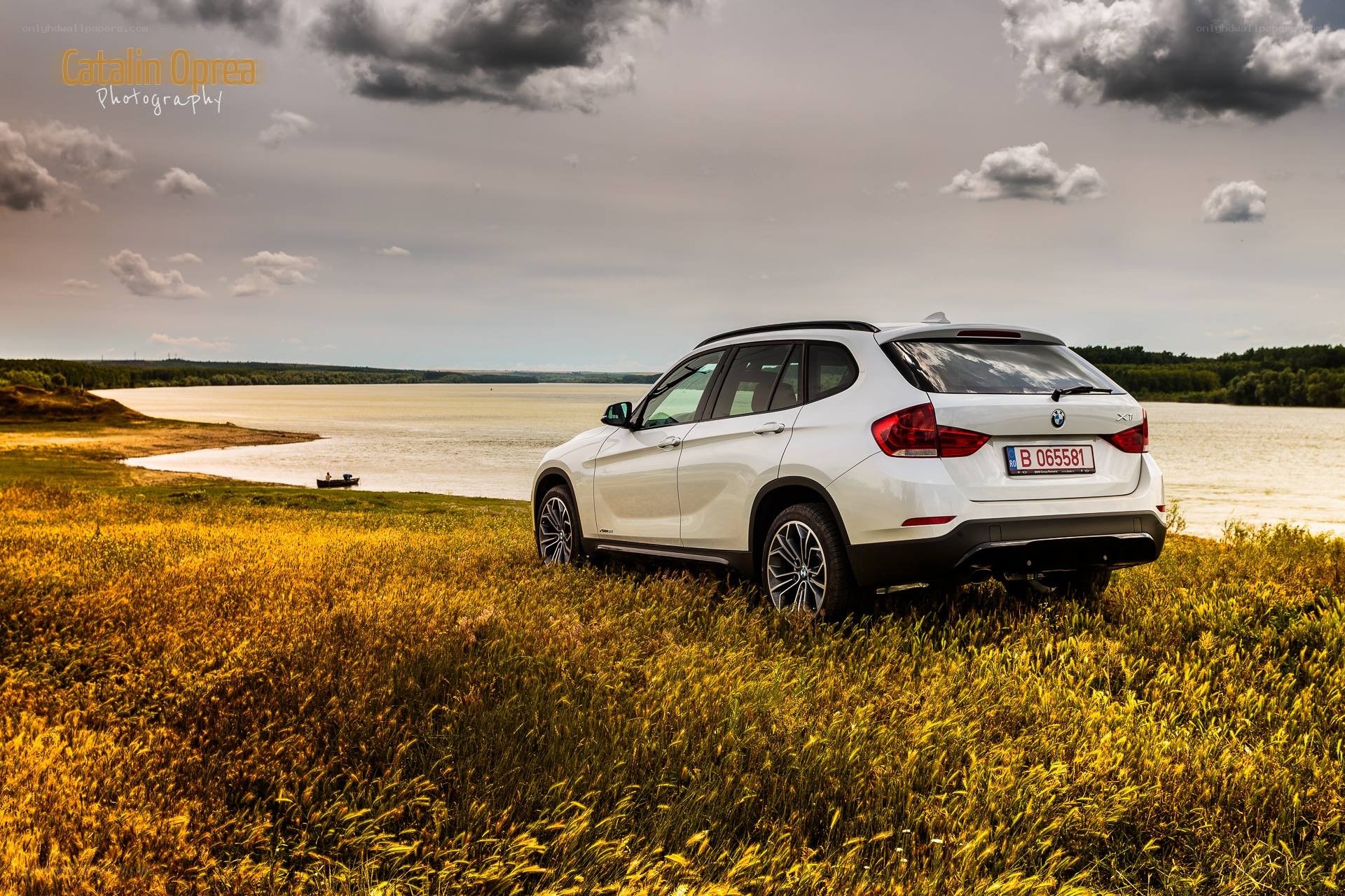 White BMW X1 by a lake