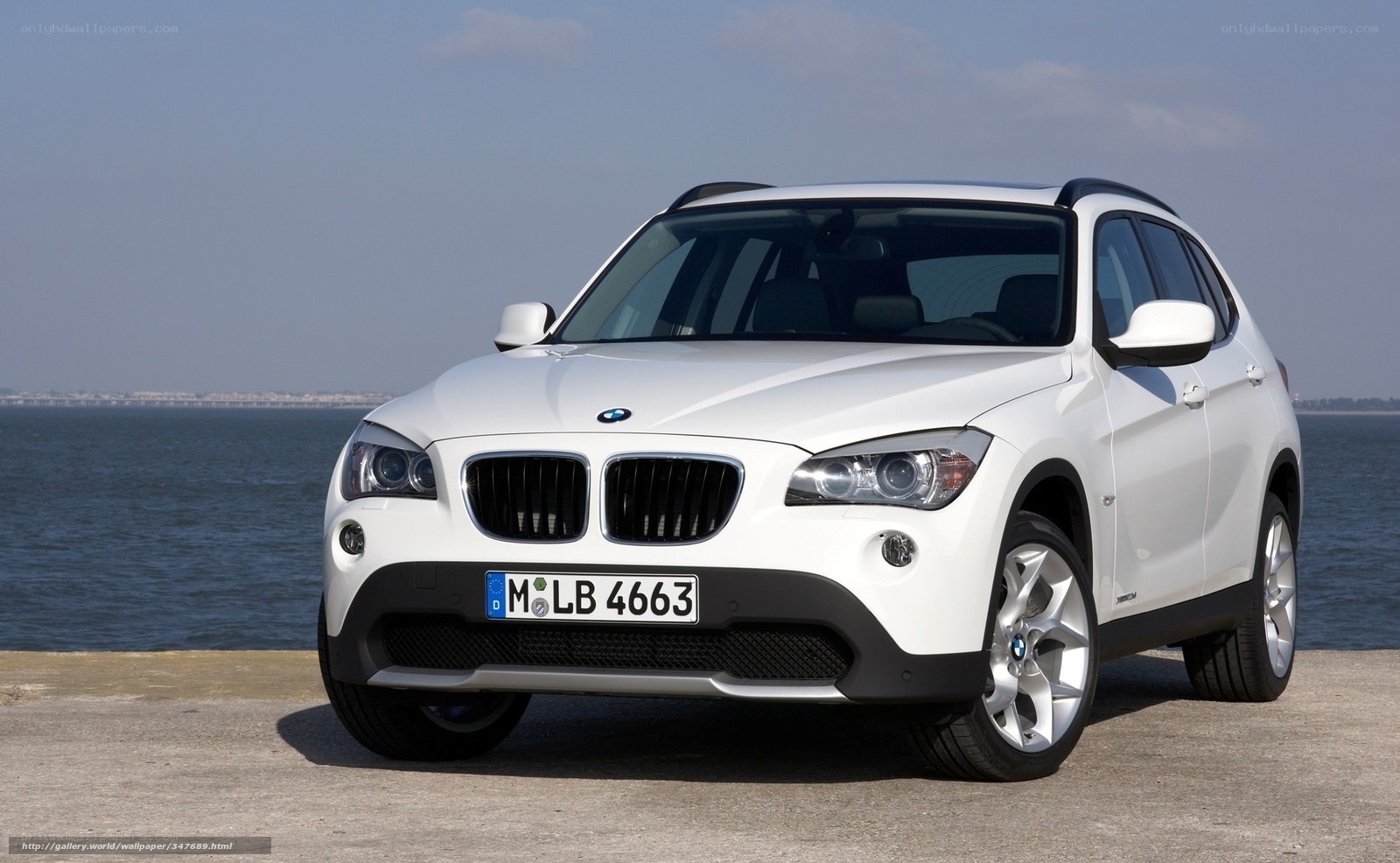 White BMW X1 by the sea