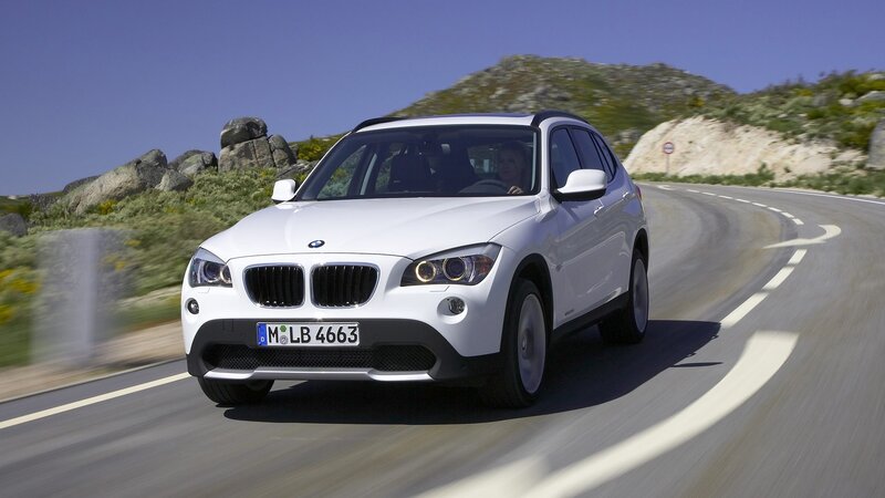 White BMW X1 on a winding road