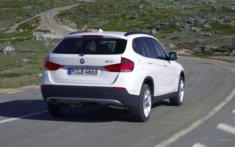White BMW X1 on a winding road