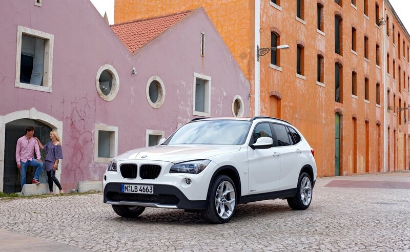 White BMW X1 on cobblestone street