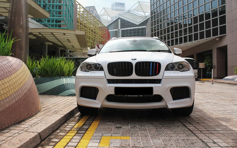 White BMW X6 M parked in city