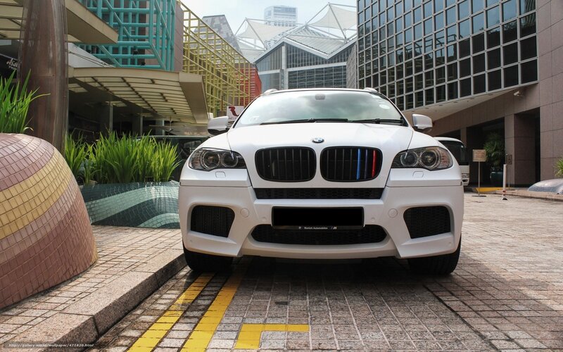 White BMW X6 M parked outside