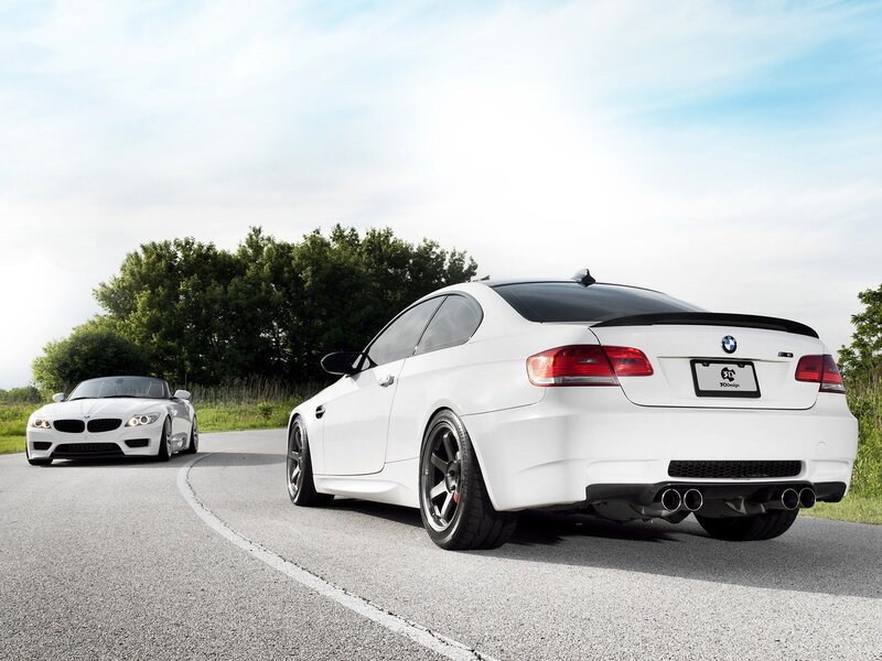 White BMWs on a road