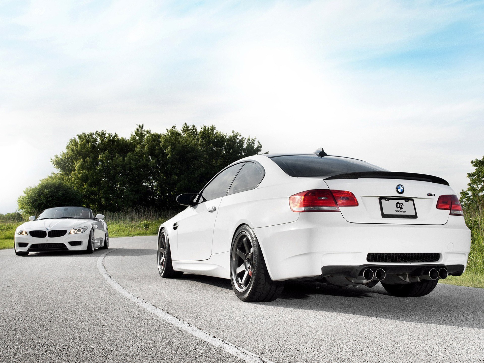 White BMWs on a winding road