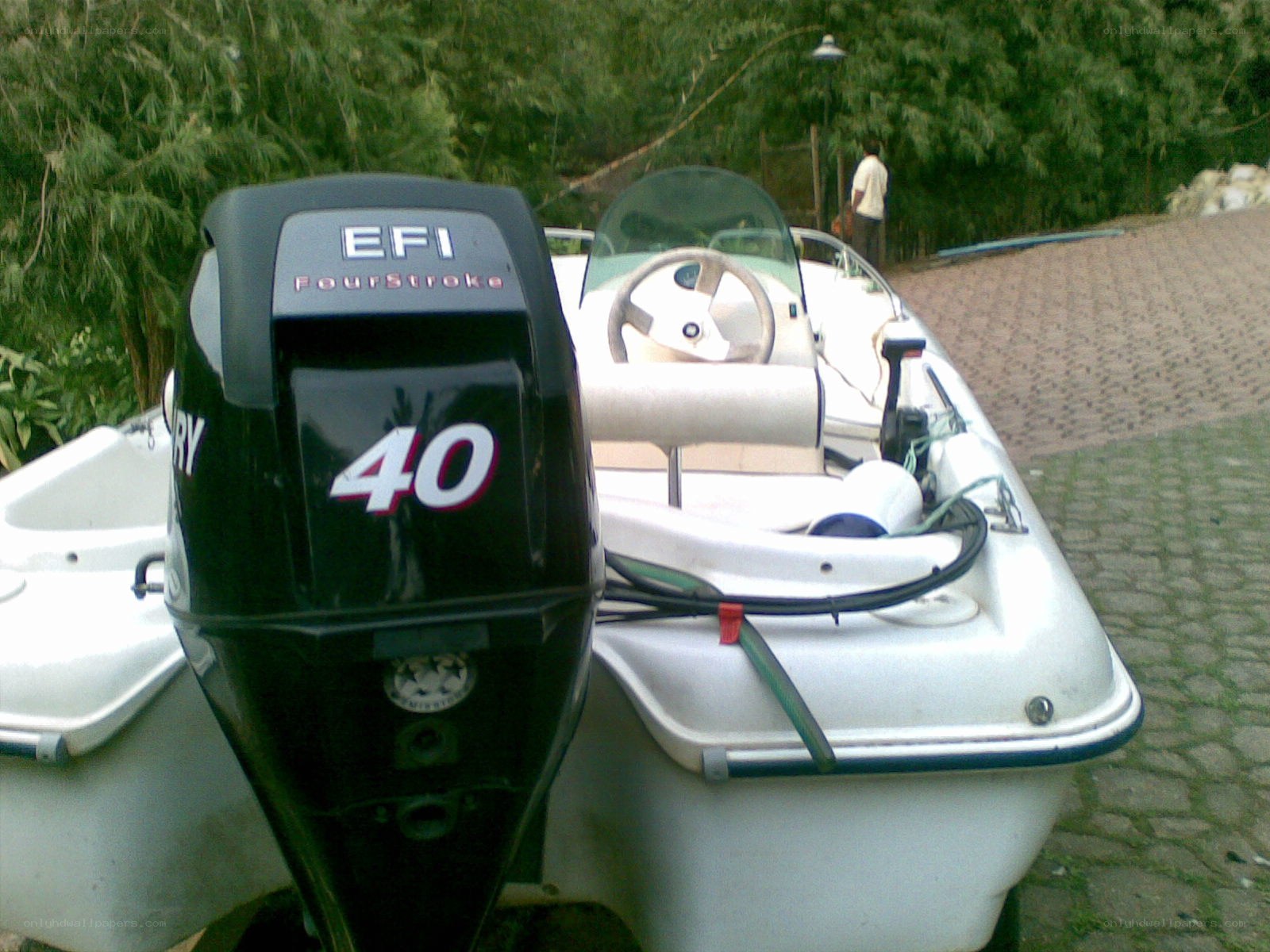 White boat with outboard motor