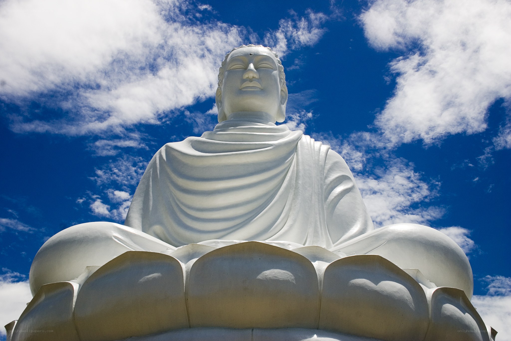 White Buddha statue against blue sky