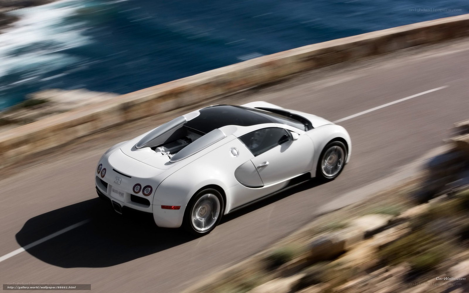 White Bugatti driving on coastal road