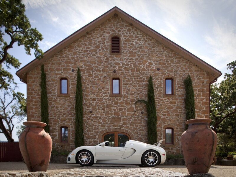 White Bugatti in front of stone building