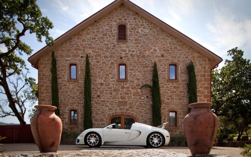 White Bugatti in front of stone house